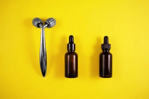 Face roller and bottle of serum Stock Photos
