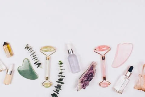 Face rollers, massager guasha scraper, eucalyptus and natural stones. Stock Photos