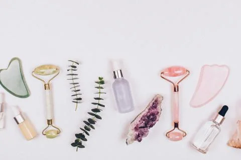 Face rollers, massager guasha scraper, eucalyptus and natural stones. Stock Photos