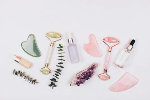 Face rollers, massager guasha scraper, eucalyptus and natural stones. Stock Photos