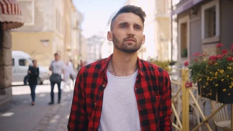 Face sad handsome young man uses phone walk in city serious blurred background Stock Footage 92067947