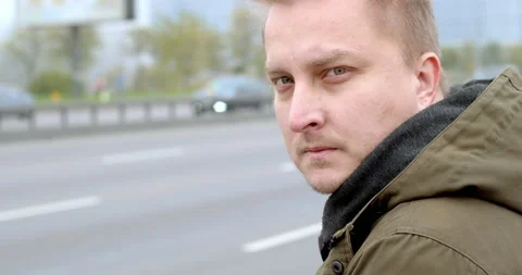 The face of a serious pensive man sitting on the street. Stock Footage 142817355