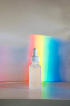 Face serum in front of rainbow Stock Photos