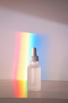 Face serum in front of rainbow Stock Photos