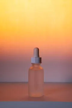 Face serum on sunset gradient Stock Photos