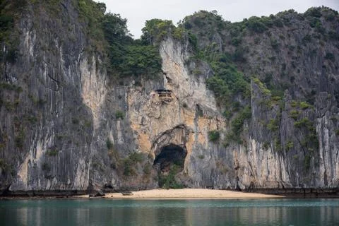 Face-shaped cave with a small beach inside limestone rocks Stock Photos