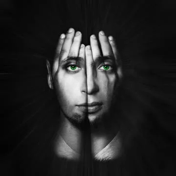 Face shines through hands, man with green eyes, double exposure Stock Photos