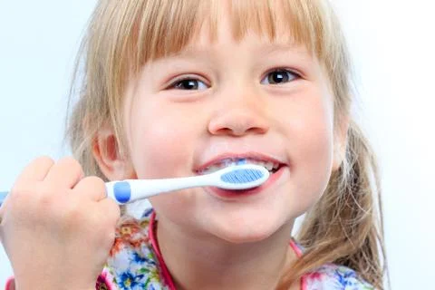 Face shot of youngster brushing teeth. Stock Photos