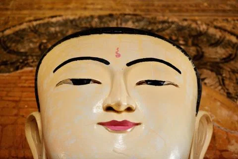 Face of sitting Buddha statue inside one of hundred old temples in Bagan, Mya Stock Photos