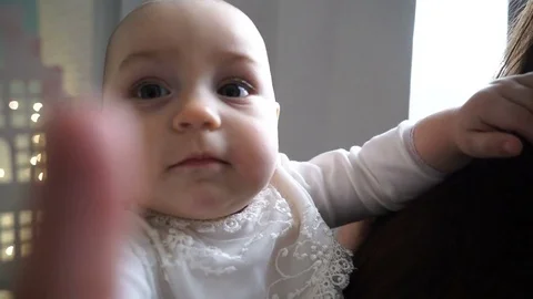 Face of small baby rotating head and looking close up Stock Footage 77443768