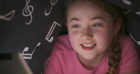 Face of smiling nad waving with hand cute teenage blonde girl, who uses tablet Stock Footage 140146494