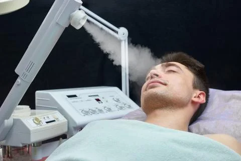 Face steaming, young man. Stock Photos