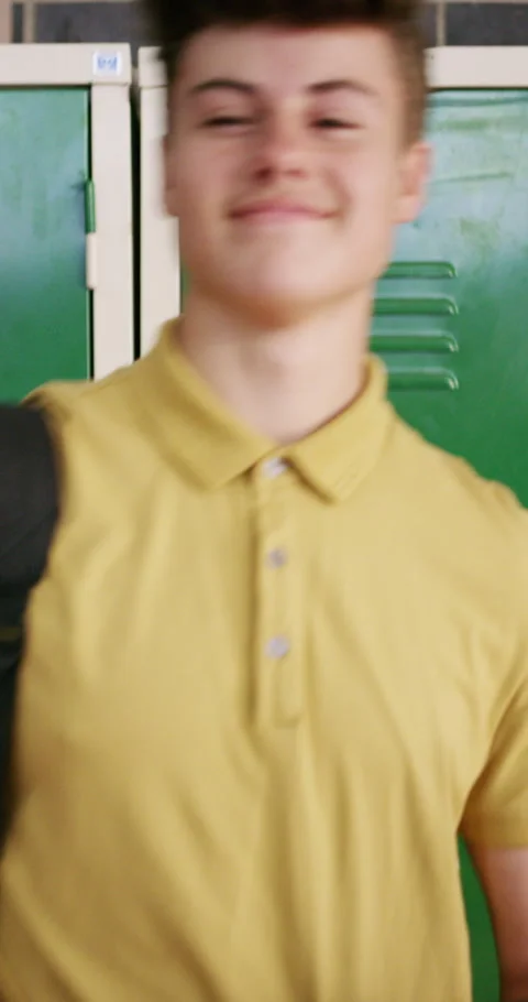 Face, student or boy with smile by locker in hallway, learning or confident for Stock Footage 334927218