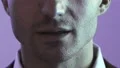The face of a talking person on the violet background 4k or 4k+ Resolution