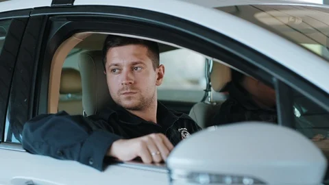 Face two men cops sitting in patrol car accepting emergence call enforcement Stock Footage 113000168