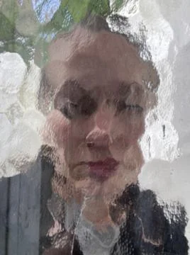 Face in wavy pattern glass window with blurred and distorted face concept for me Stock Photos
