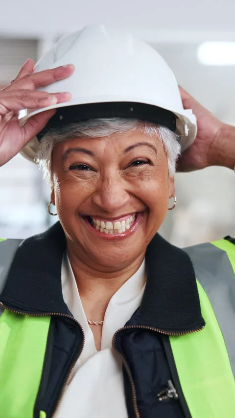 Face, woman and engineer at construction site with safety helmet, smile and Stock Footage 342311402