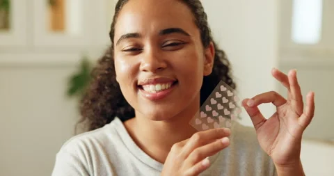 Face, woman and pimple patch in home with skincare, blemish control or smile for Video stock 330571639