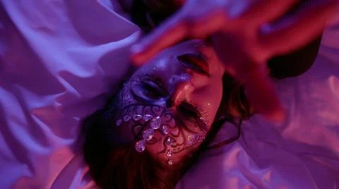 Face a woman with beautiful makeup, a pattern and with rhinestones on her face Stock Photos