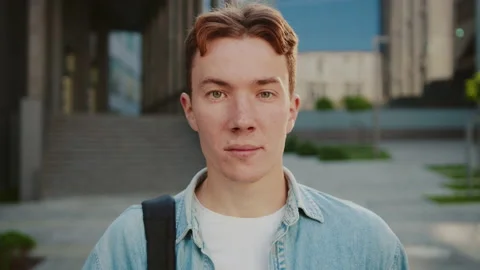 Face young attractive student man with red hair standing look at camera at the Stock Footage 142048592