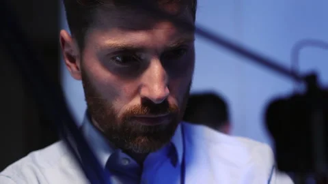 Face of young bearded technician fixing bugs in 3d printing machine cooperating Stock Footage 153745044
