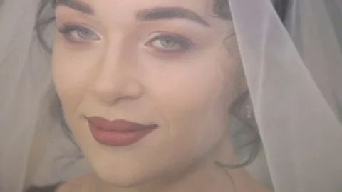 Face of the young beautiful bride under the white wedding veil Stock Footage 71472568