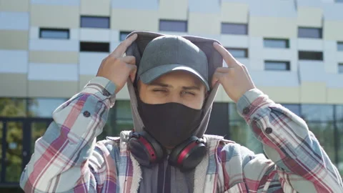 Face Of Young Guy In Black Mask To Protect Against Viruses. He Stands On The Stock Footage 143284897