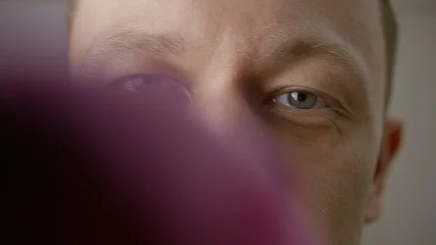 Face of the young man close-up, wipes the glass directly looking into the camera Stock Footage 127862279
