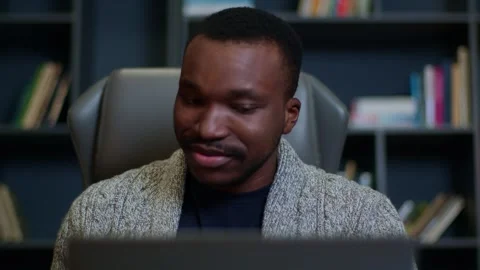 Face of a young man with a gap in his teeth talking online at home, face of a Видео 263630405