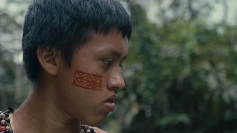 Face of a Young tribe man paddling in a Canoe in Amazon Stock Footage 270460985