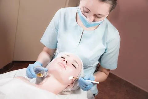Face of a young woman close-up lying down cosmetic procedure is performed Stock Photos