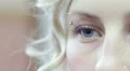 face of a young woman with her blue eye - macro HD Footage