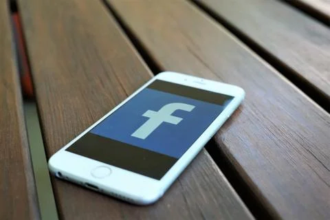 Facebook app icon on the screen of a mobile phone Stock Photos