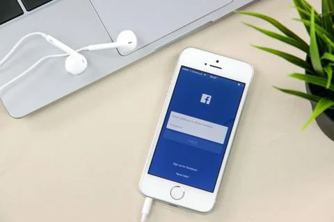 Facebook App on iPhone SE Stock Photos