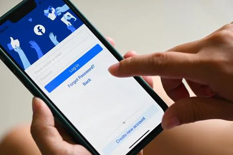 Facebook application icon on Apple iPhone 13 Pro, holding smartphone with log Stock Photos