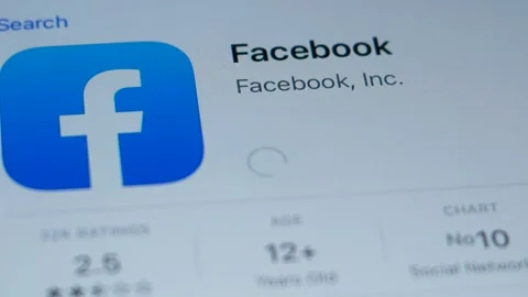 Facebook application icon on mobile device screen. The Facebook program is downl Stock Footage 163040396