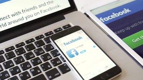 Facebook application on the iPad, iPhone and Macbook gadgets Stock Footage 81207429