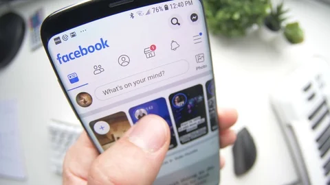 Facebook Feed Browsing on a Smartphone Mobile Device Stock Footage 117600323
