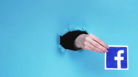 Facebook icon global communication hand paper hole Stock Footage 140899869