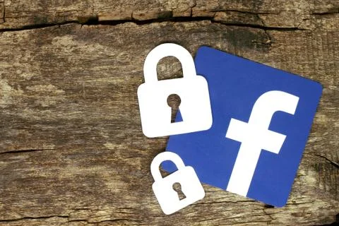 Facebook icon with locks placed on old wooden background Stock Photos
