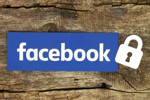 Facebook logo with lock placed on old wooden background Stock Photos