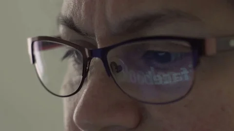 Facebook Logo Reflection in Glasses of Middle Aged Female Stock Footage 74911390