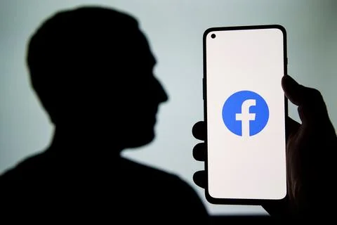 Facebook logo on screen Stock Photos
