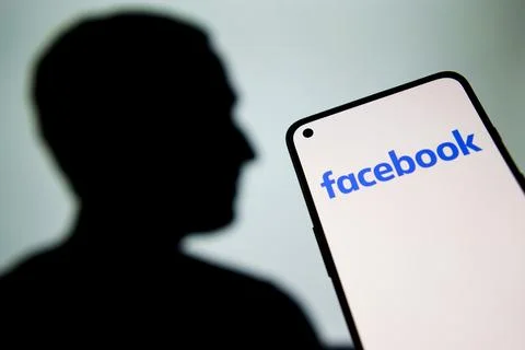 Facebook logo on screen Stock Photos