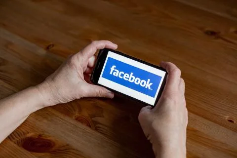 Facebook logo sign application screen on mobile phone online retail service Stock Photos