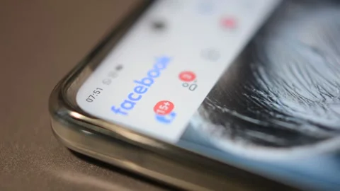 Facebook social network application. facebook by meta icon logo on phone screen. Stock-Footage 302344581