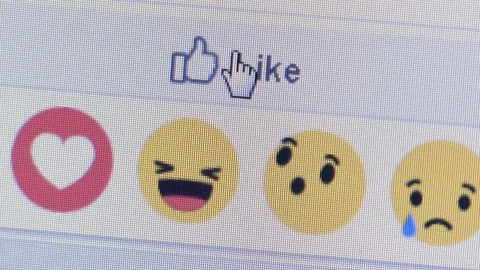 Facebook user selects Like button - emoticons appear below Stock Footage 94666702