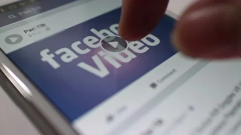 Facebook Video banner playing on Smartphone with user tapping Stock Footage 58654800