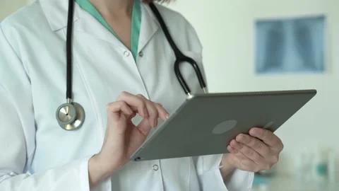 Faceless close up view of female doctors hands using tablet Stock Footage 170033167