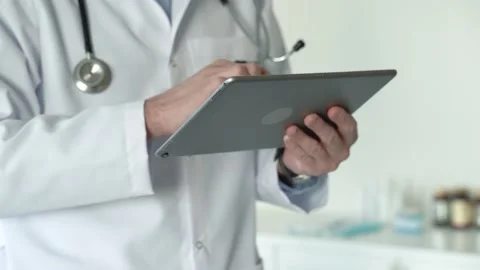 Faceless close up view of male doctors hands using tablet Stock Footage 170033255